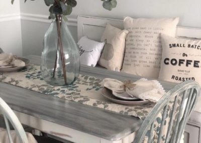 a table with chairs, and a plant centerpiece